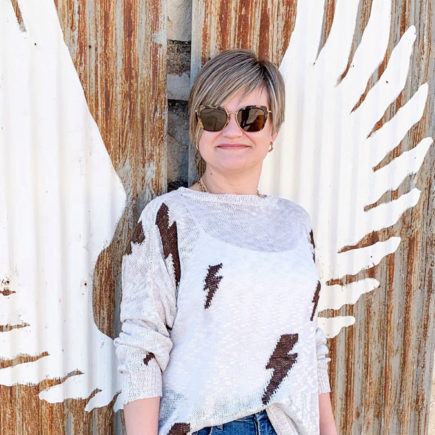 lightning bolt sweater and jeans and sneakers